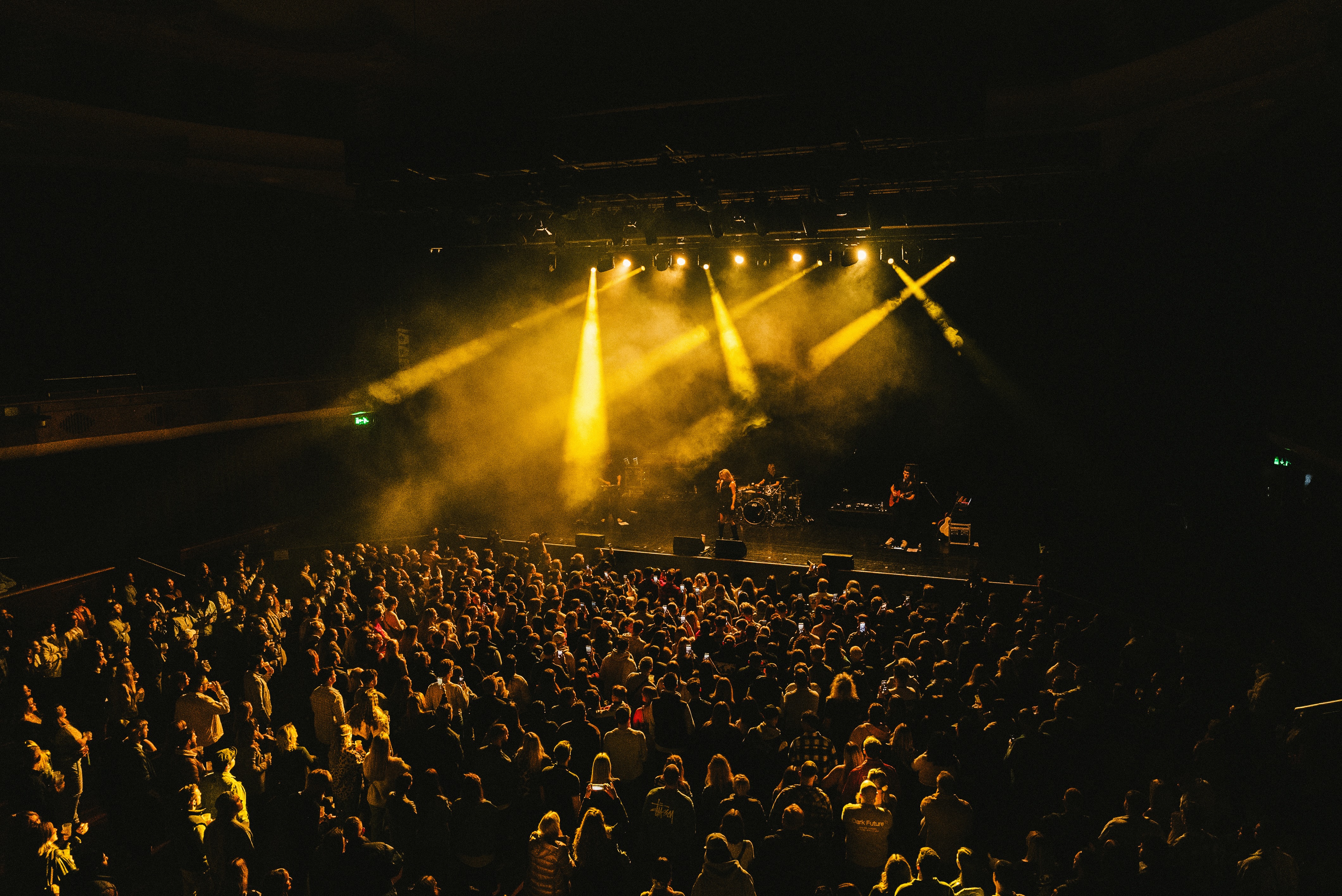 Callum Garland performing live under warm stage lighting