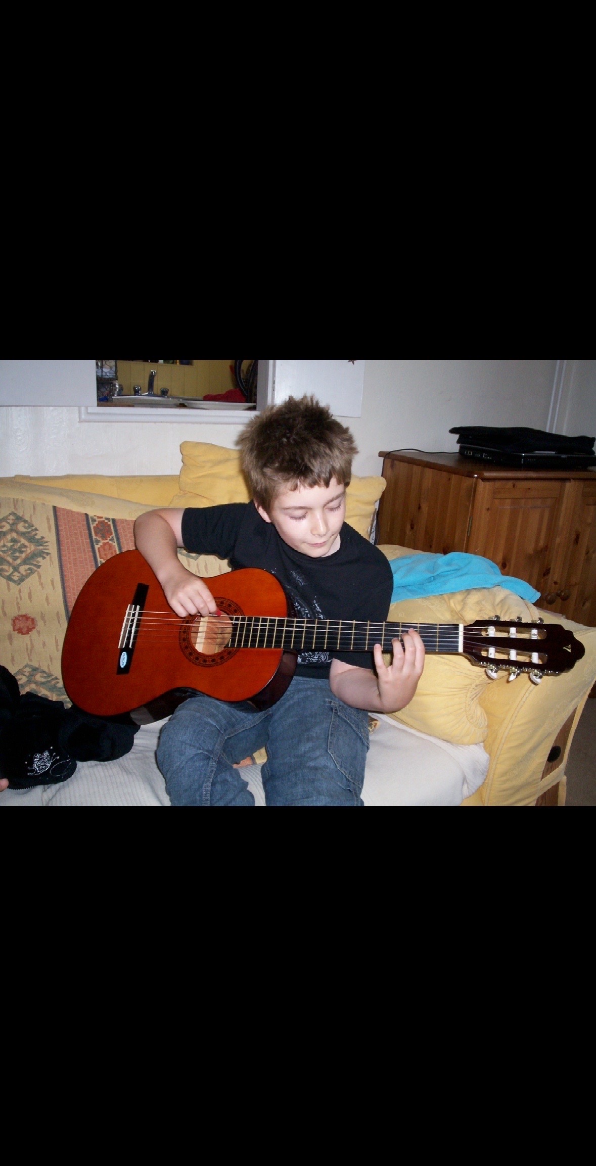 Callum Garland as a boy, learning guitar